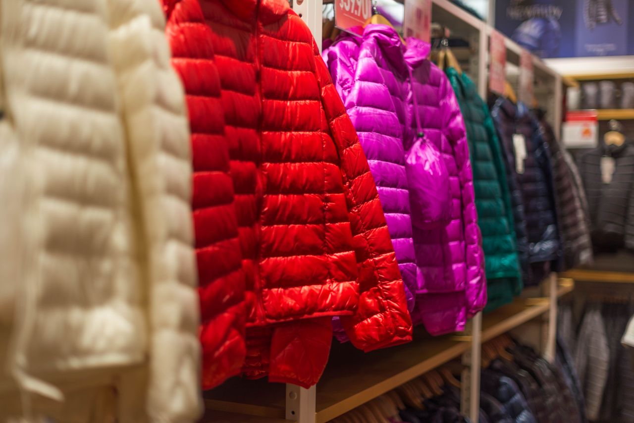 creative Vibrant winter jackets on display in a clothing store, showcasing a variety of colors for shoppers.